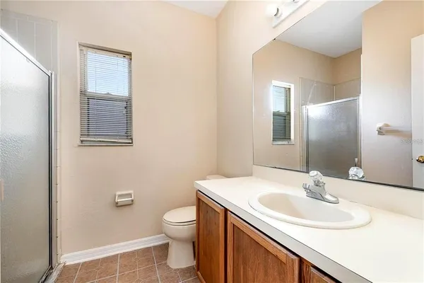 a bathroom with a sink toilet and mirror