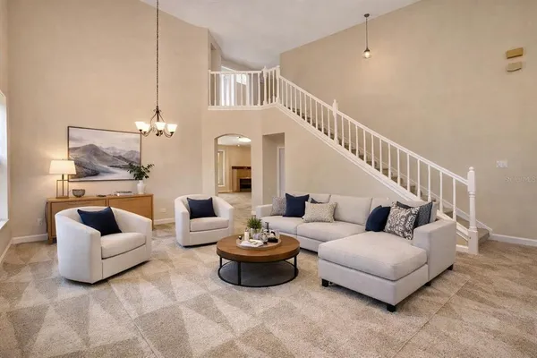a living room with furniture and white walls
