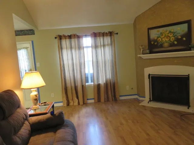 a view of hallway with wooden floor