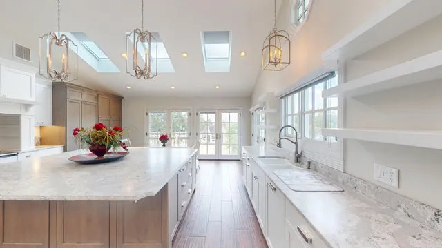 a living room with furniture wooden floor and a floor to ceiling window