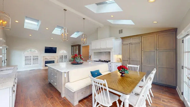 a living room with furniture dining table a flat screen tv and a large window