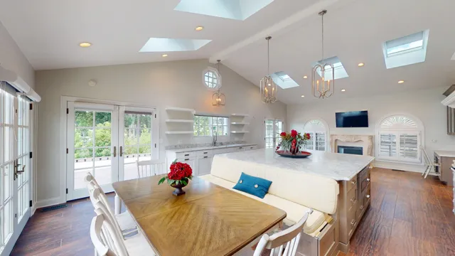 a kitchen with a white center island and cabinets