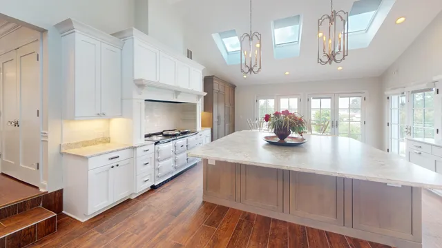 a view of a livingroom with furniture a fireplace and wooden floor
