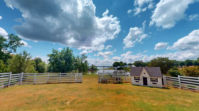 a view of a lake with a house in the background