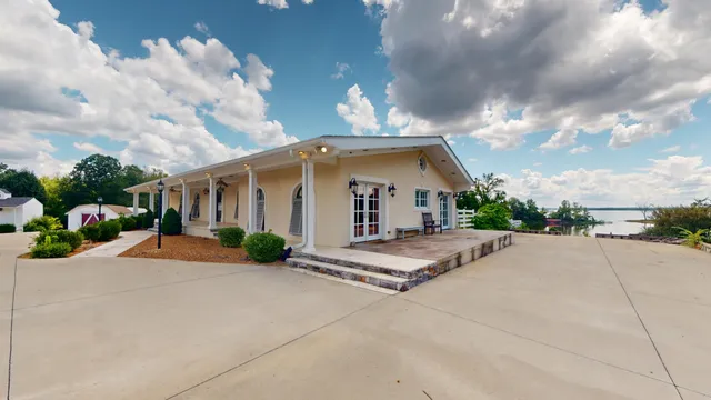 a view of a house with backyard and porch