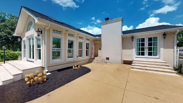 a front view of a house with a sitting area