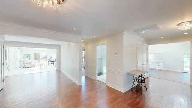 a room with wooden floor and windows