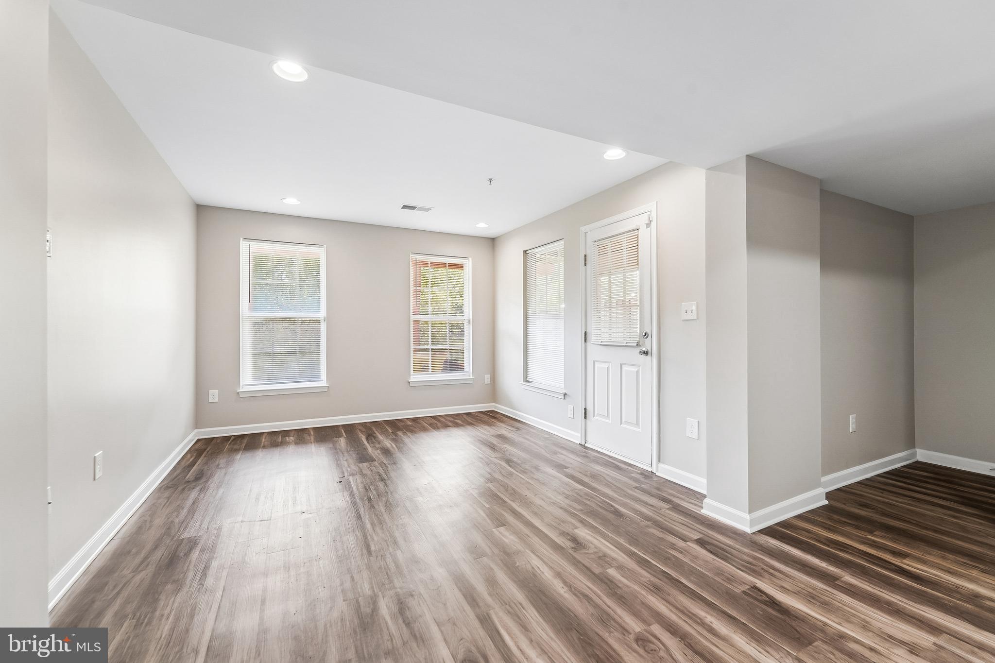 1461 Pangbourne Way Hanover, MD 21076 - Photo 38 of 51 a view of an empty room with wooden floor and window