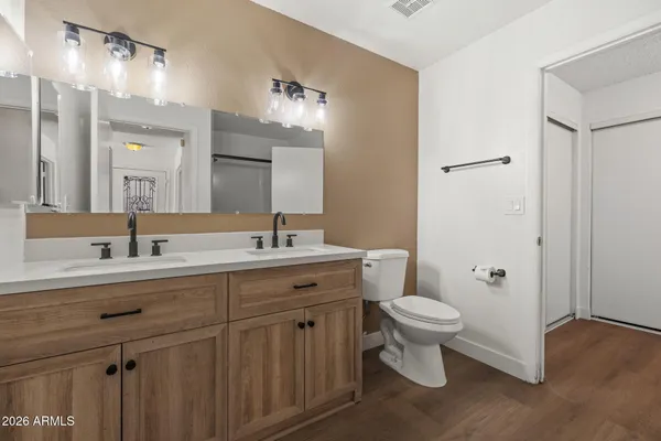 a bathroom with a toilet sink and mirror
