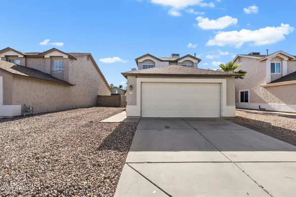 a view of a house with a yard and garage