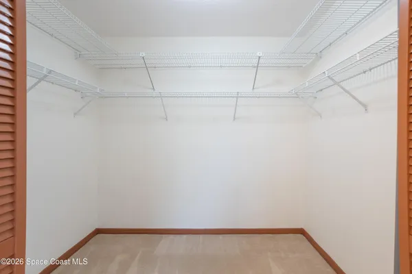 an empty room with a ceiling fan and a window