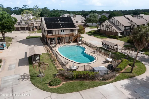 an aerial view of a house with outdoor space patio and lake view