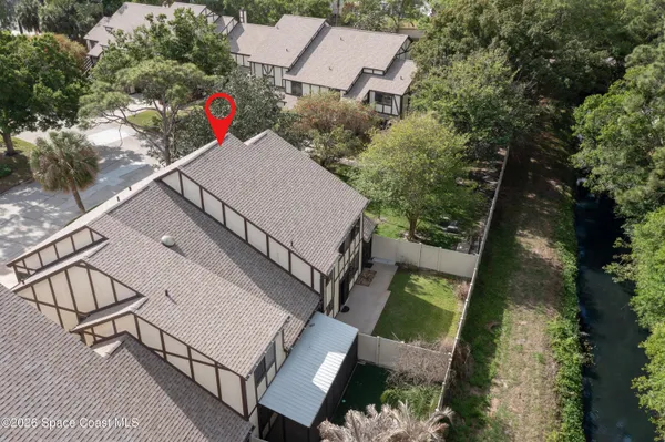 an aerial view of a house with outdoor space