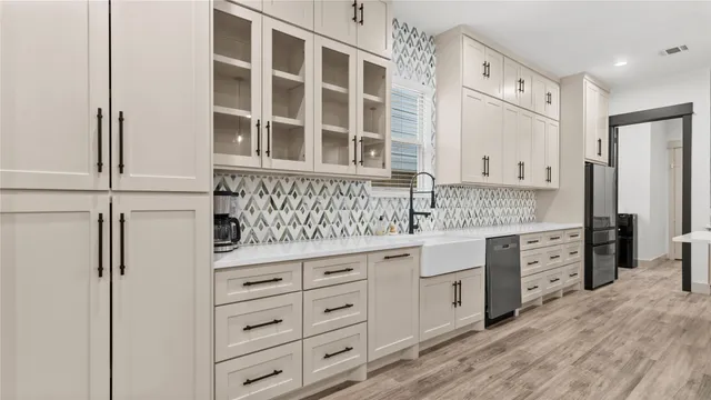 a kitchen with granite countertop white cabinets and white appliances