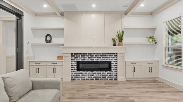 a living room with furniture a fireplace and a window