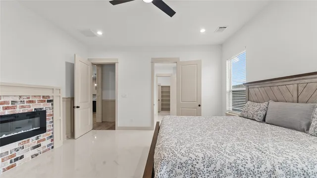 a bedroom with a bed and a fireplace