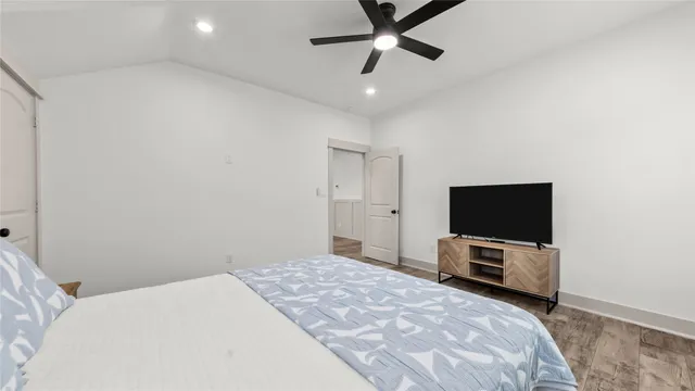 a bedroom with a bed and a flat screen tv