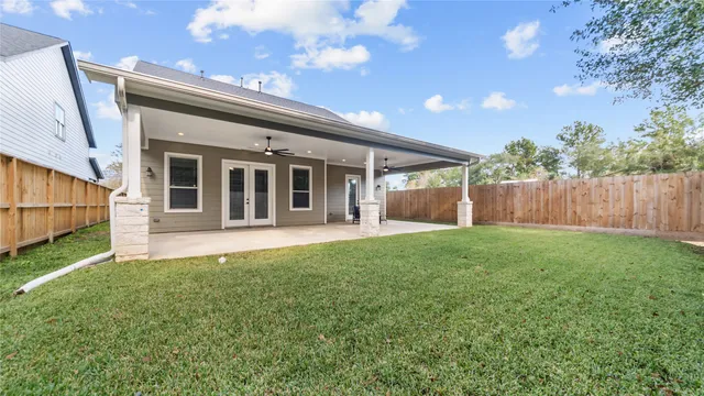 a view of a house with backyard and porch
