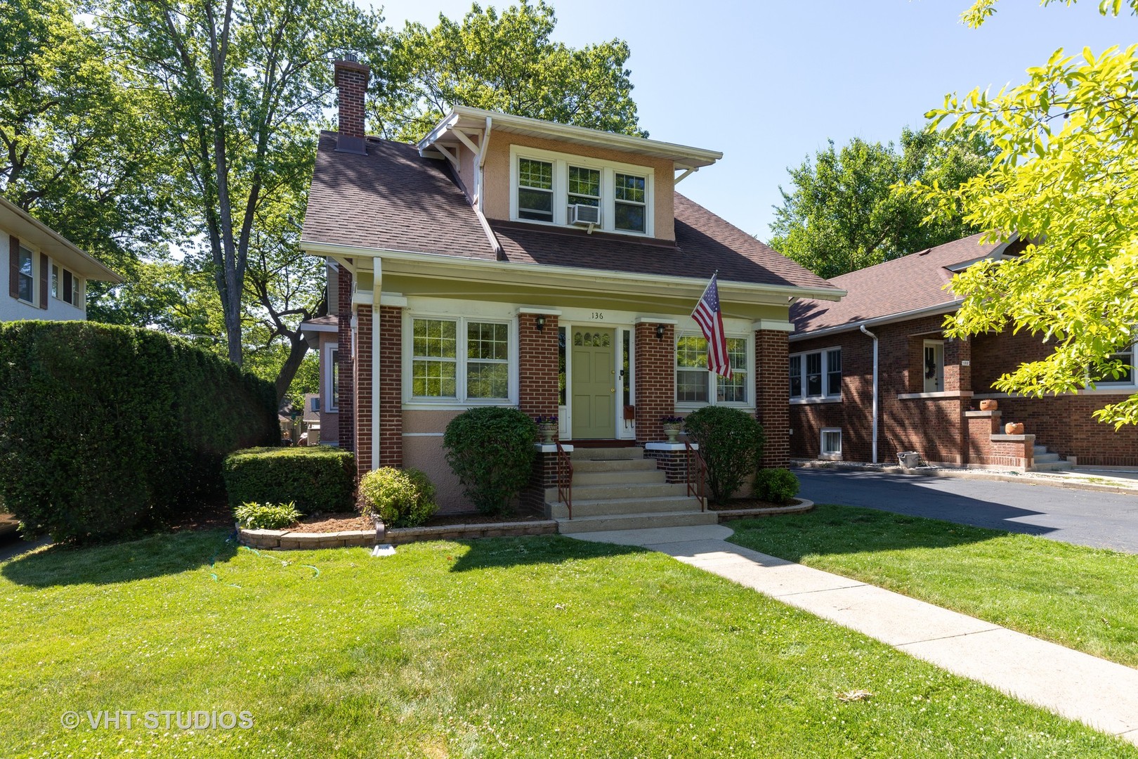 a front view of a house with a yard and porch