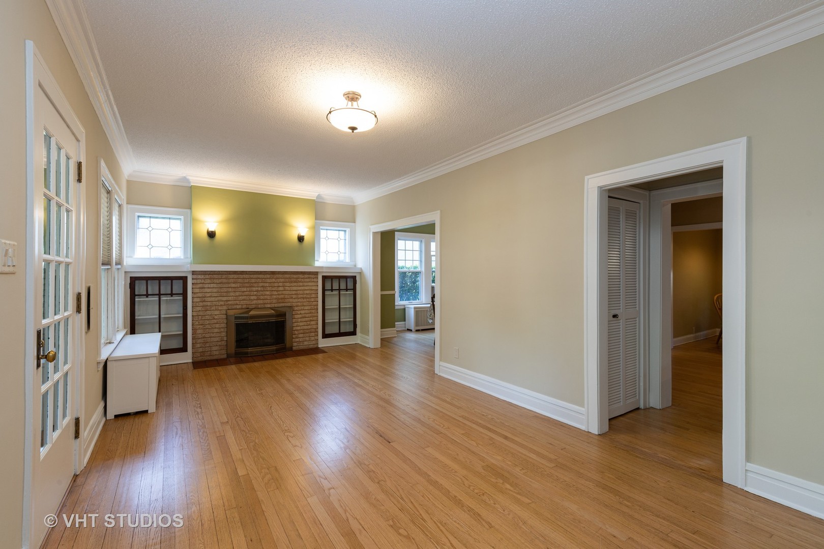 136 Barrypoint Road Riverside, IL 60546 - Photo 2 of 19 an empty room with wooden floor fireplace and windows