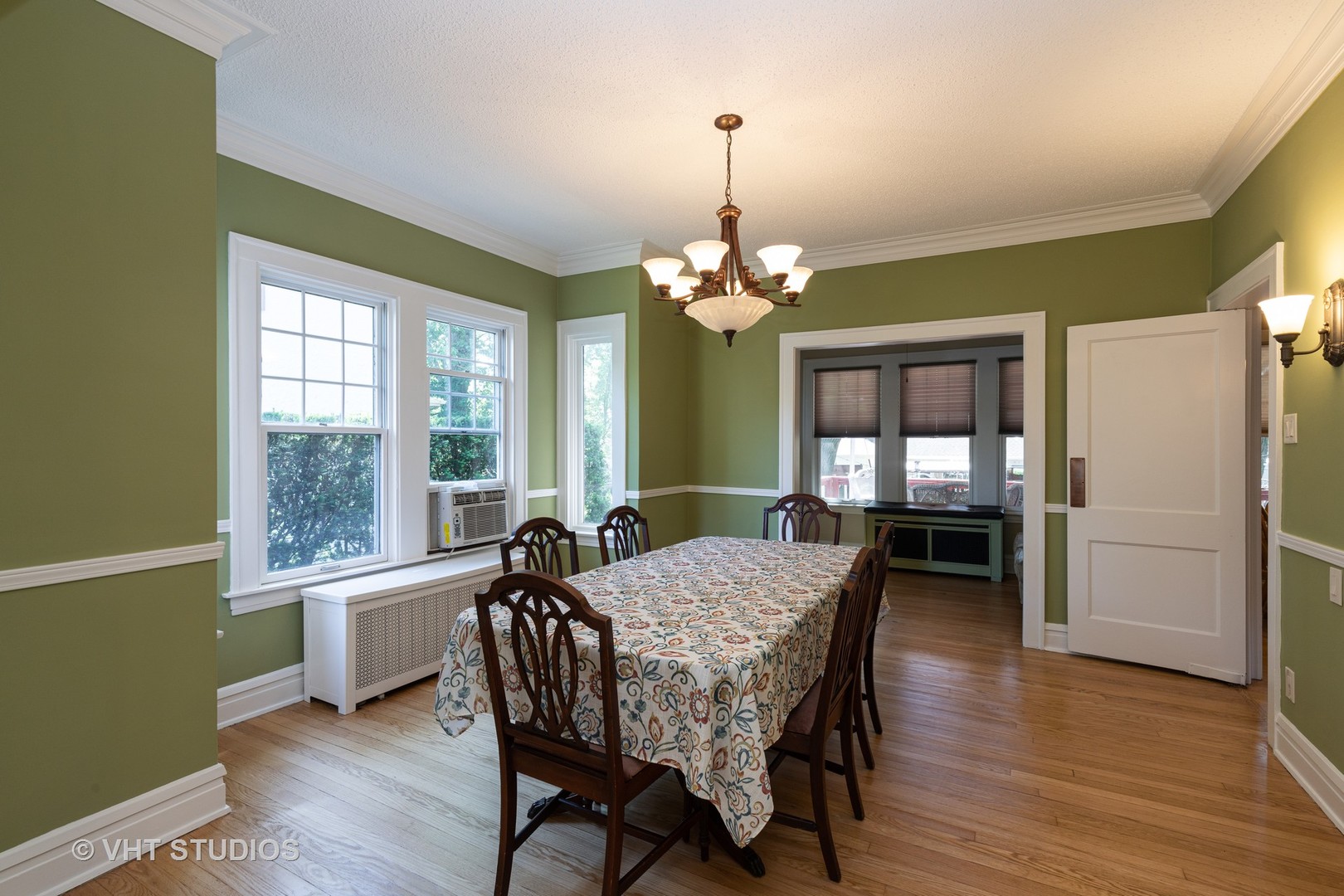 136 Barrypoint Road Riverside, IL 60546 - Photo 4 of 19 a dining room with furniture a chandelier and wooden floor