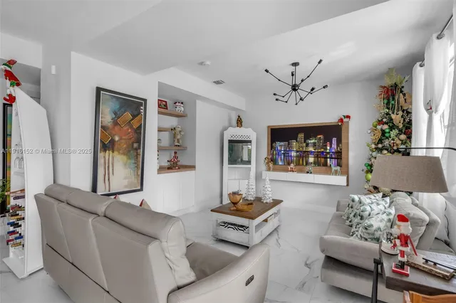 a living room with furniture flat screen tv and a large window