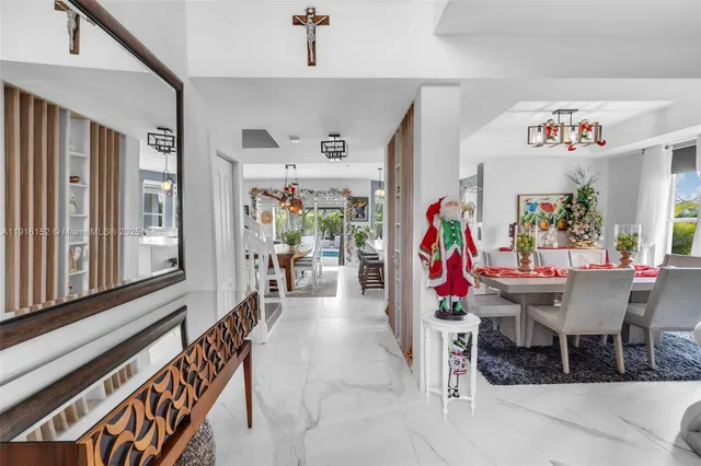 a view of a dining room with furniture one side kitchen view