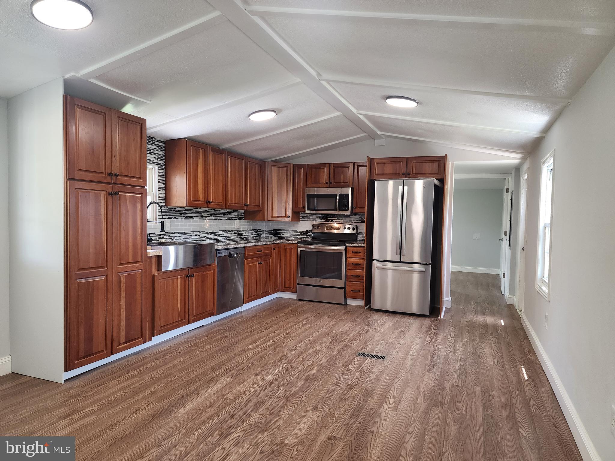 41 Mountain View Terrace Newville, PA 17241 - Photo 9 of 34 a kitchen with stainless steel appliances wooden floors a refrigerator and a stove top oven