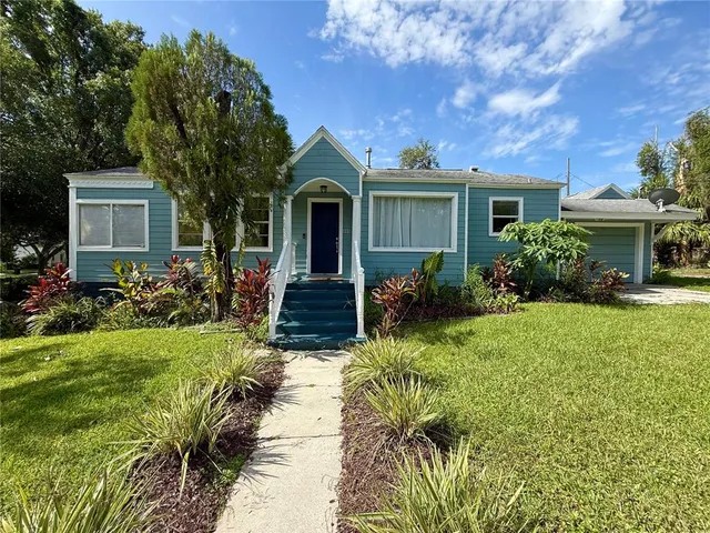 a front view of house with yard and green space