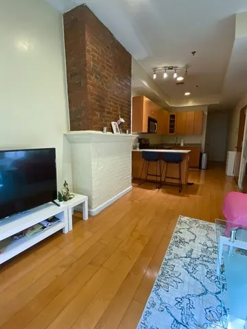 a lobby with furniture and a flat screen tv