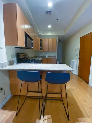a kitchen with a table chairs sink and cabinets