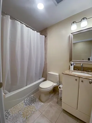 a bathroom with a toilet a sink and a mirror