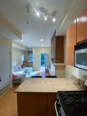 a kitchen with kitchen island a sink appliances and cabinets