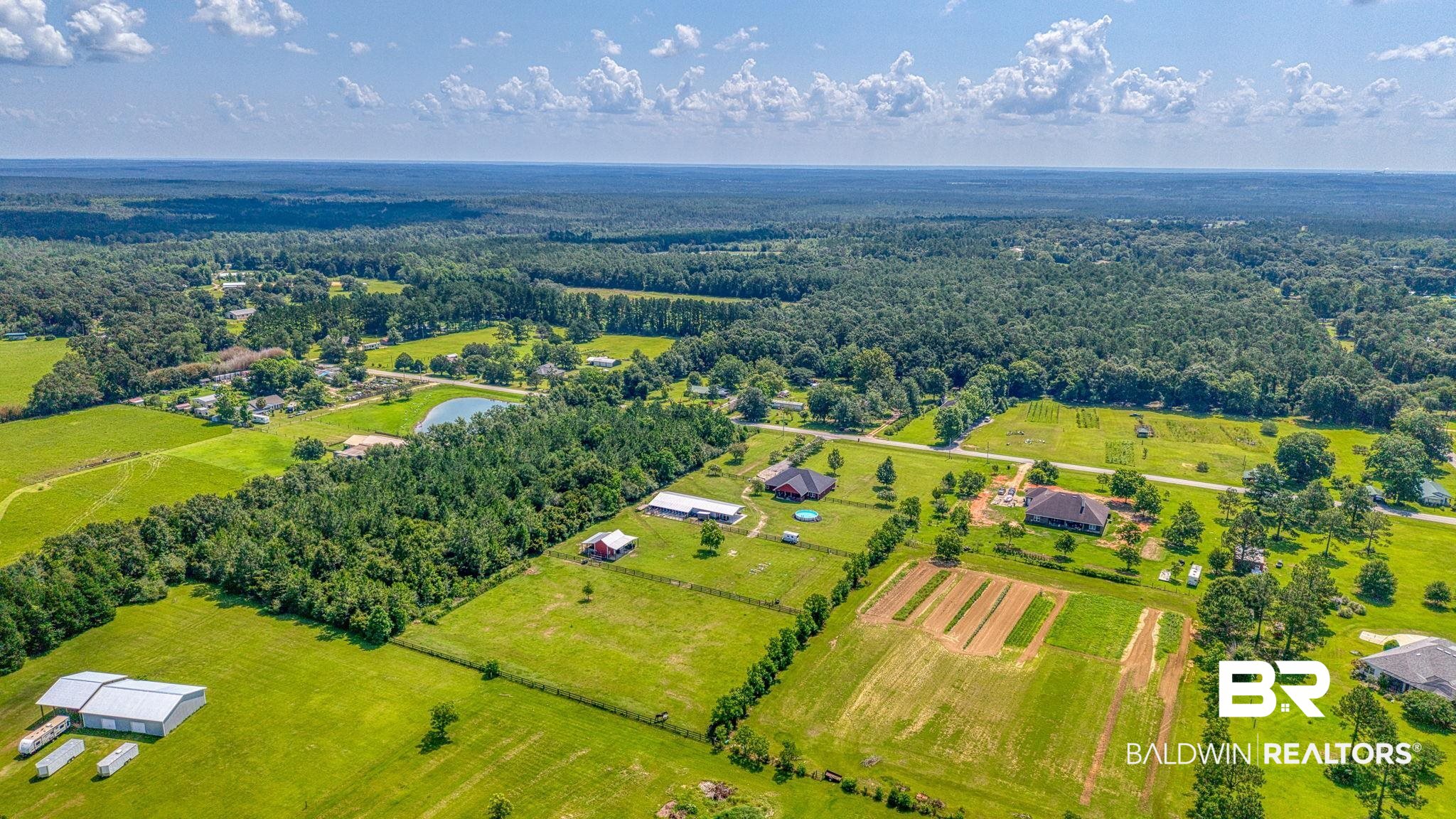 26895 C R Watson Road Robertsdale, AL 36567 - Photo 79 of 89 Expansive acreage featuring multiple residences, a natural pond, and mature tree lines