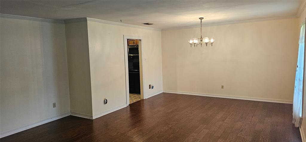 2 Woodfern Lane Haughton, LA 71037 - Photo 10 of 33 an empty room with wooden floor chandelier and entryway