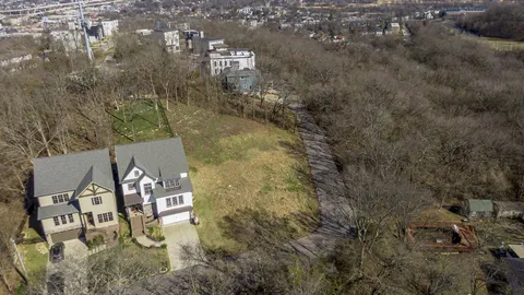 an aerial view of houses with yard