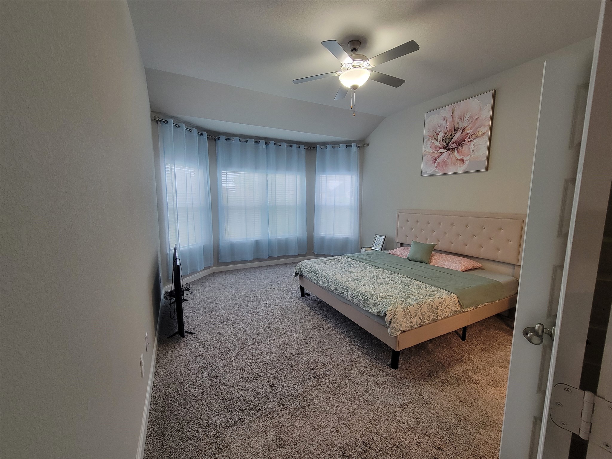10803 Sugar Pne Lane Rosharon, TX 77583 - Photo 13 of 18 a bedroom with a bed and a chandelier