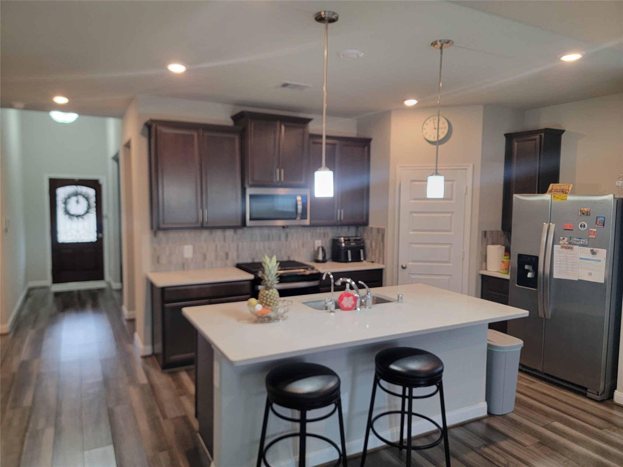10803 Sugar Pne Lane Rosharon, TX 77583 - Photo 7 of 18 a kitchen with stainless steel appliances a table chairs refrigerator and microwave