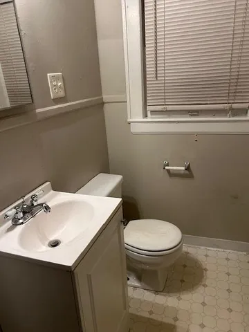a bathroom with a sink toilet and a mirror
