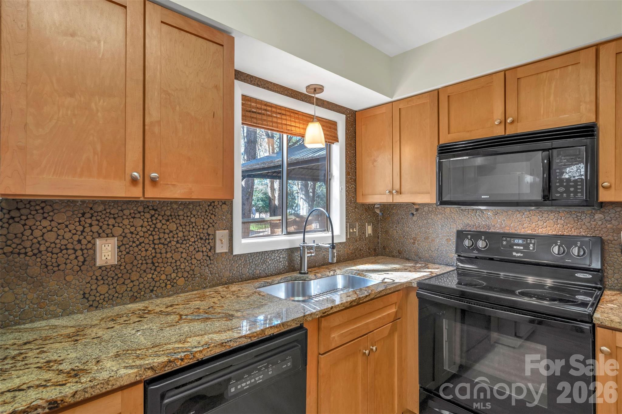 1121 Mai Kai Way Fort Mill, SC 29708 - Photo 11 of 35 a kitchen with granite countertop a sink stove and microwave