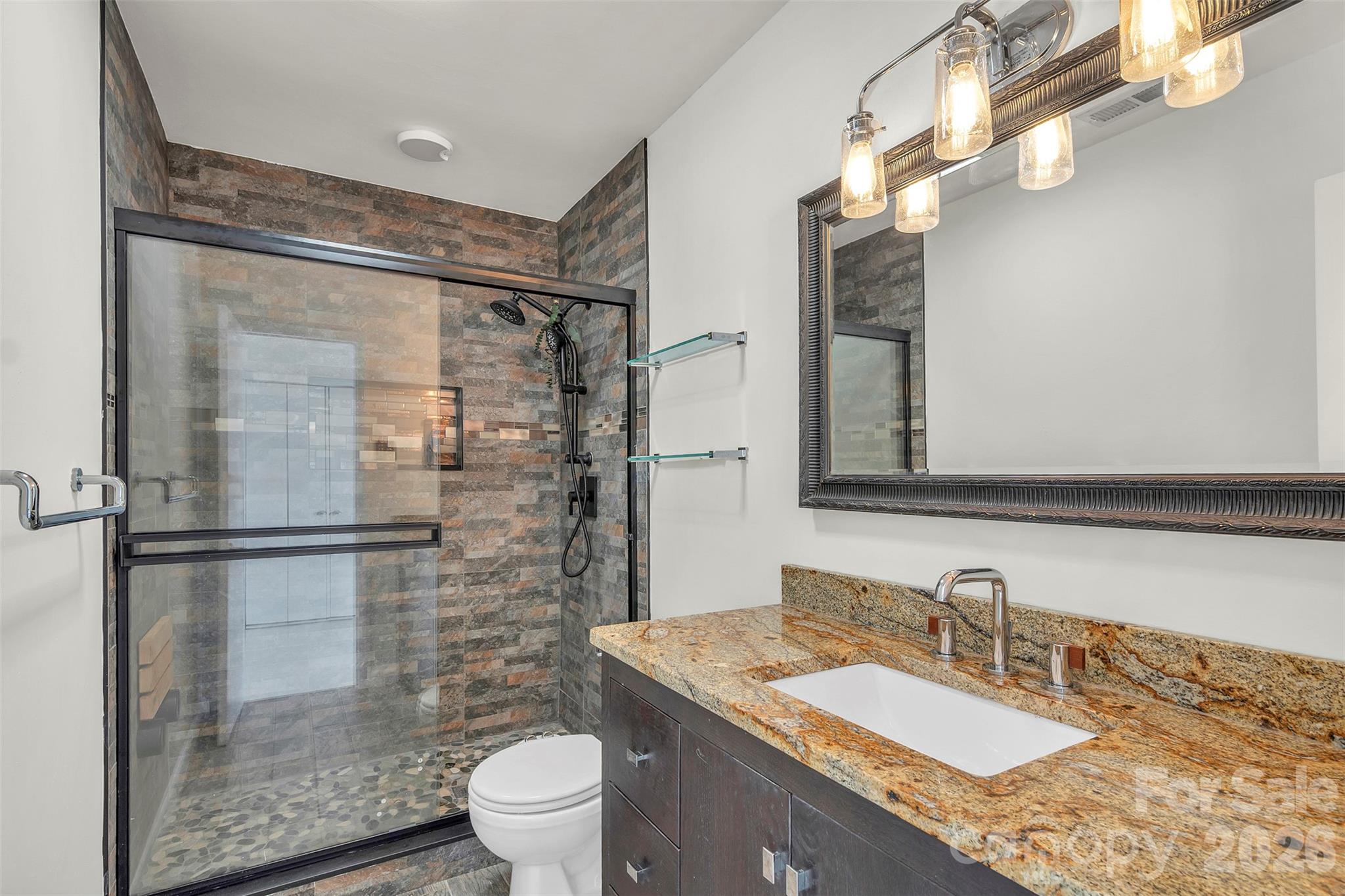 1121 Mai Kai Way Fort Mill, SC 29708 - Photo 25 of 35 a bathroom with a granite countertop shower sink vanity mirror and toilet