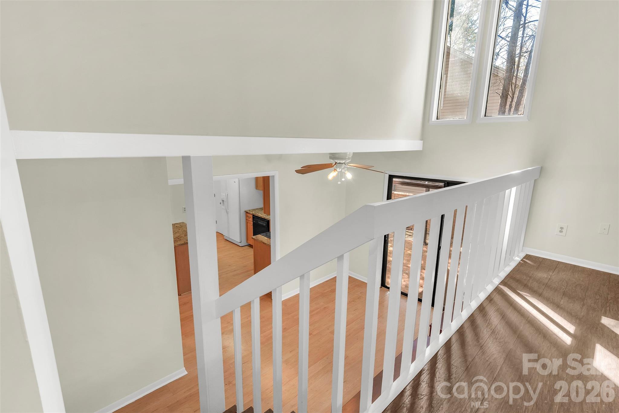 1121 Mai Kai Way Fort Mill, SC 29708 - Photo 8 of 35 a view of staircase with lots of frames on wall and wooden floor