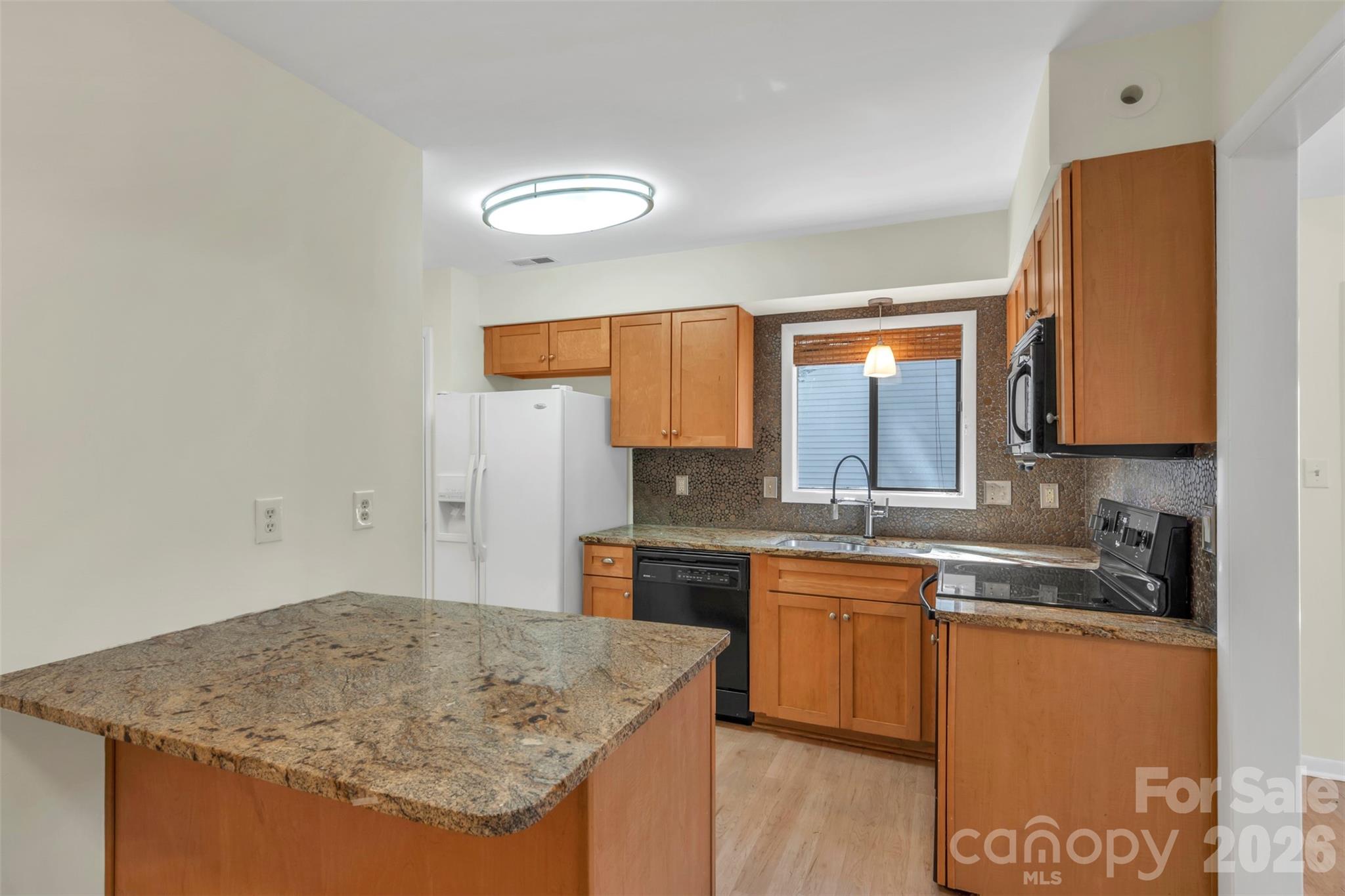 1121 Mai Kai Way Fort Mill, SC 29708 - Photo 10 of 35 a kitchen with stainless steel appliances granite countertop a sink and cabinets