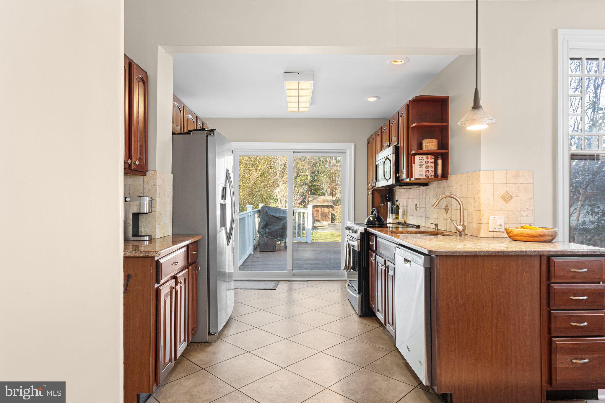 109 West Euclid Avenue Haddonfield, NJ 08033 - Photo 15 of 32 a kitchen with stainless steel appliances granite countertop a stove top oven