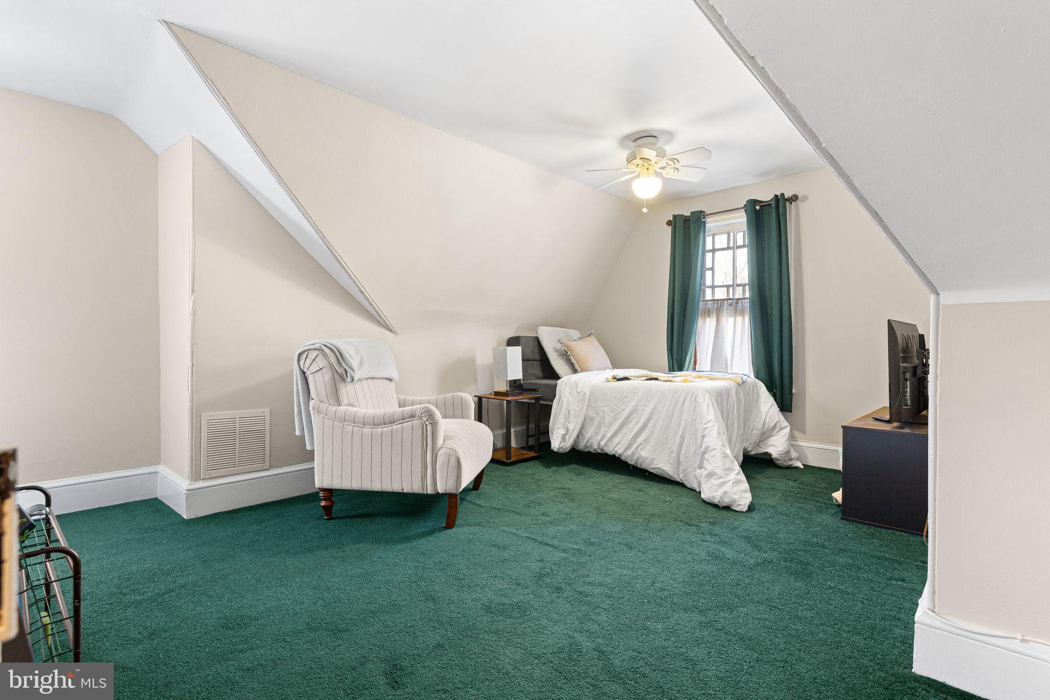 109 West Euclid Avenue Haddonfield, NJ 08033 - Photo 26 of 32 a spacious bedroom with a bed and a chandelier