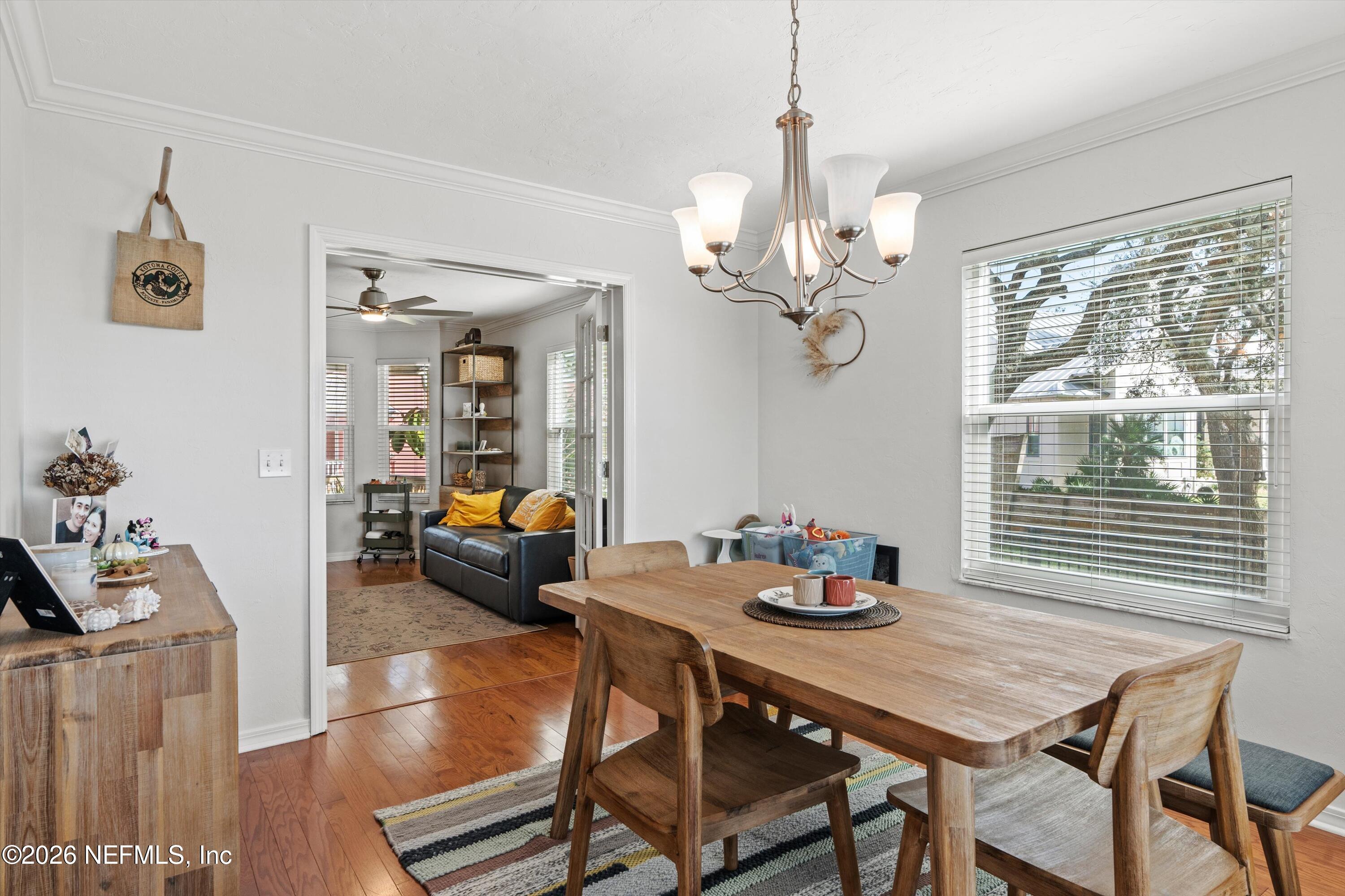 5532 Sunset Landing Circle St. Augustine, FL 32080 - Photo 13 of 43 a view of a dining room with furniture wooden floor and a chandelier