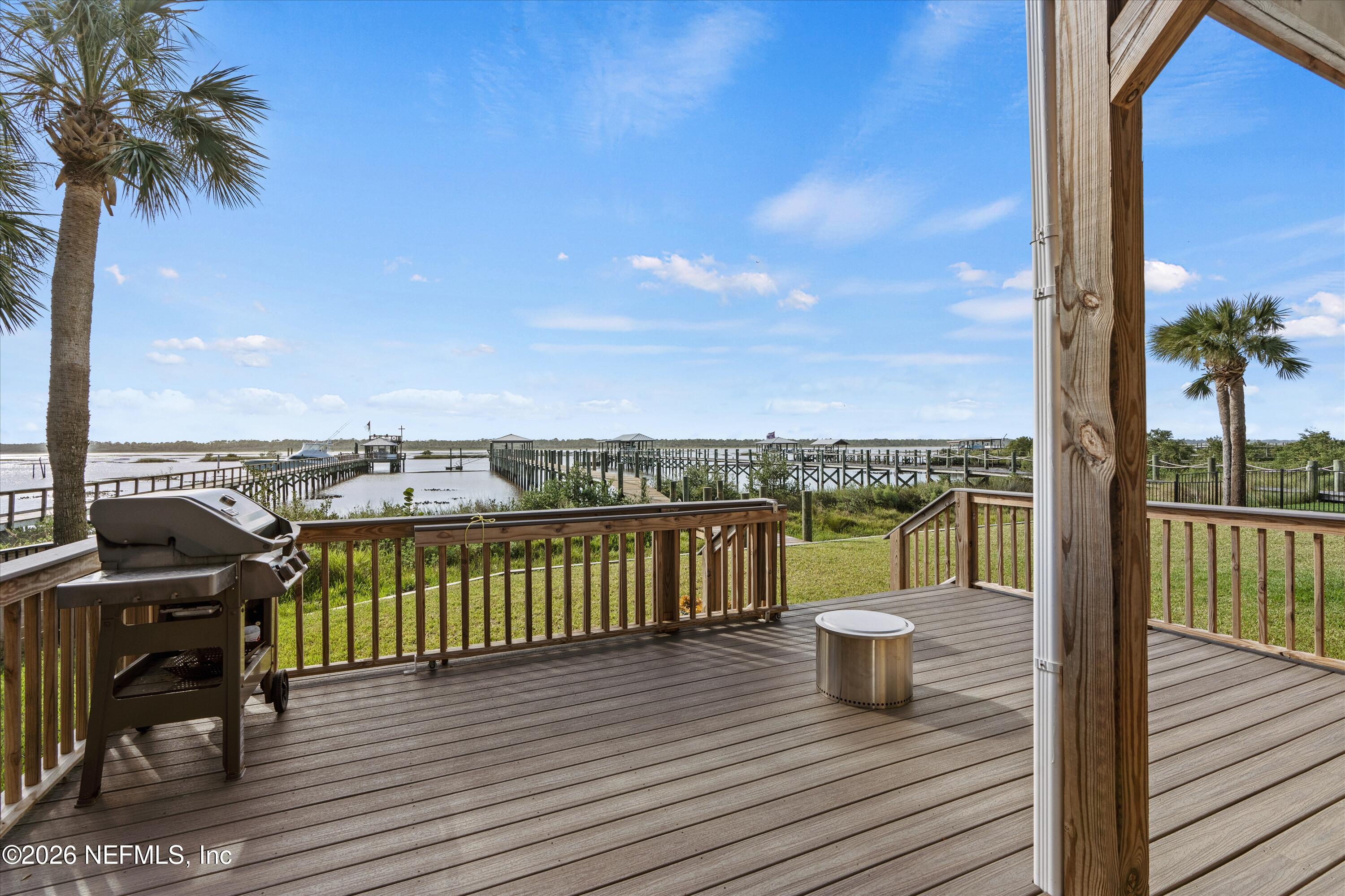 5532 Sunset Landing Circle St. Augustine, FL 32080 - Photo 14 of 43 a view of a balcony with wooden floor and iron stairs