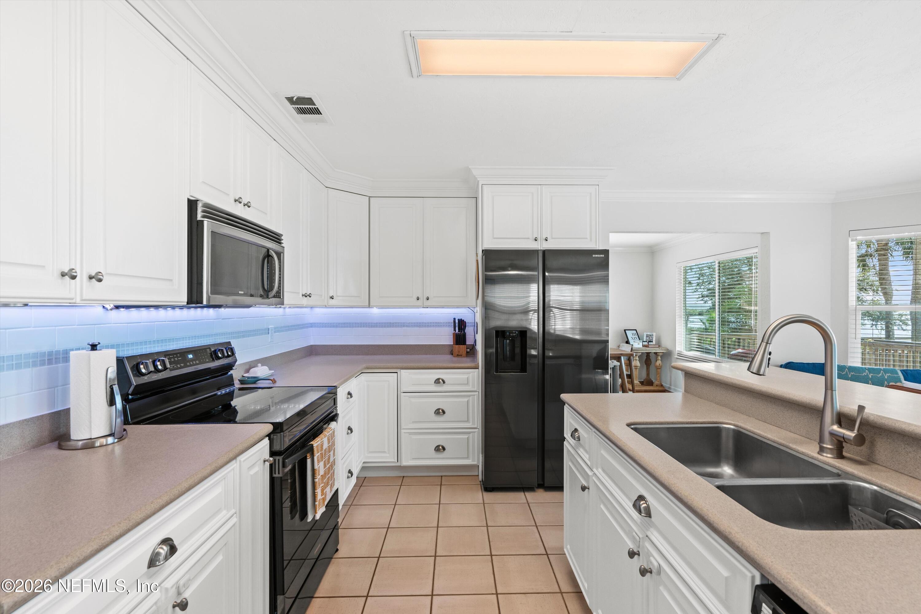 5532 Sunset Landing Circle St. Augustine, FL 32080 - Photo 15 of 43 a kitchen with a sink stove and refrigerator