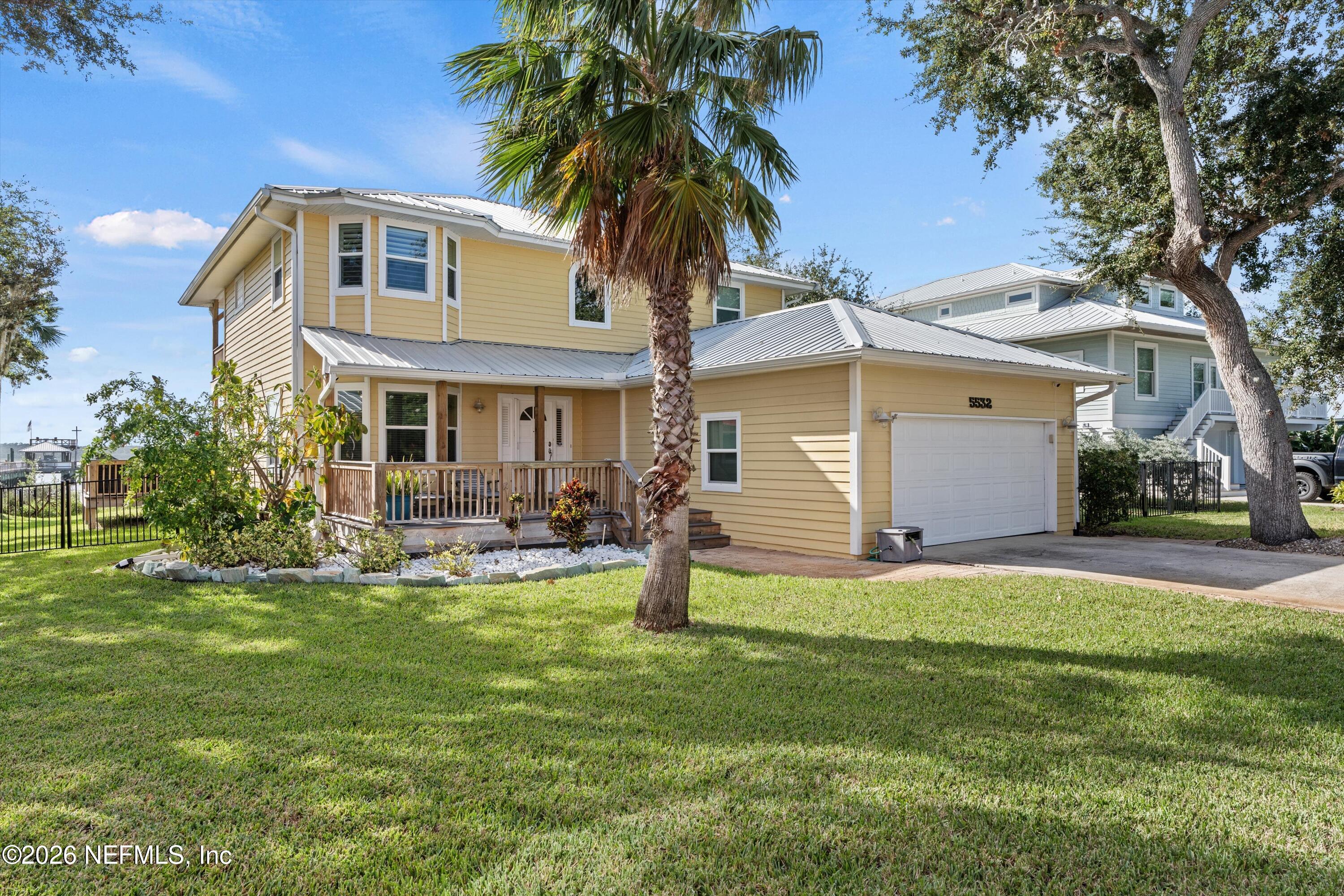 5532 Sunset Landing Circle St. Augustine, FL 32080 - Photo 17 of 43 a front view of a house with garden and trees