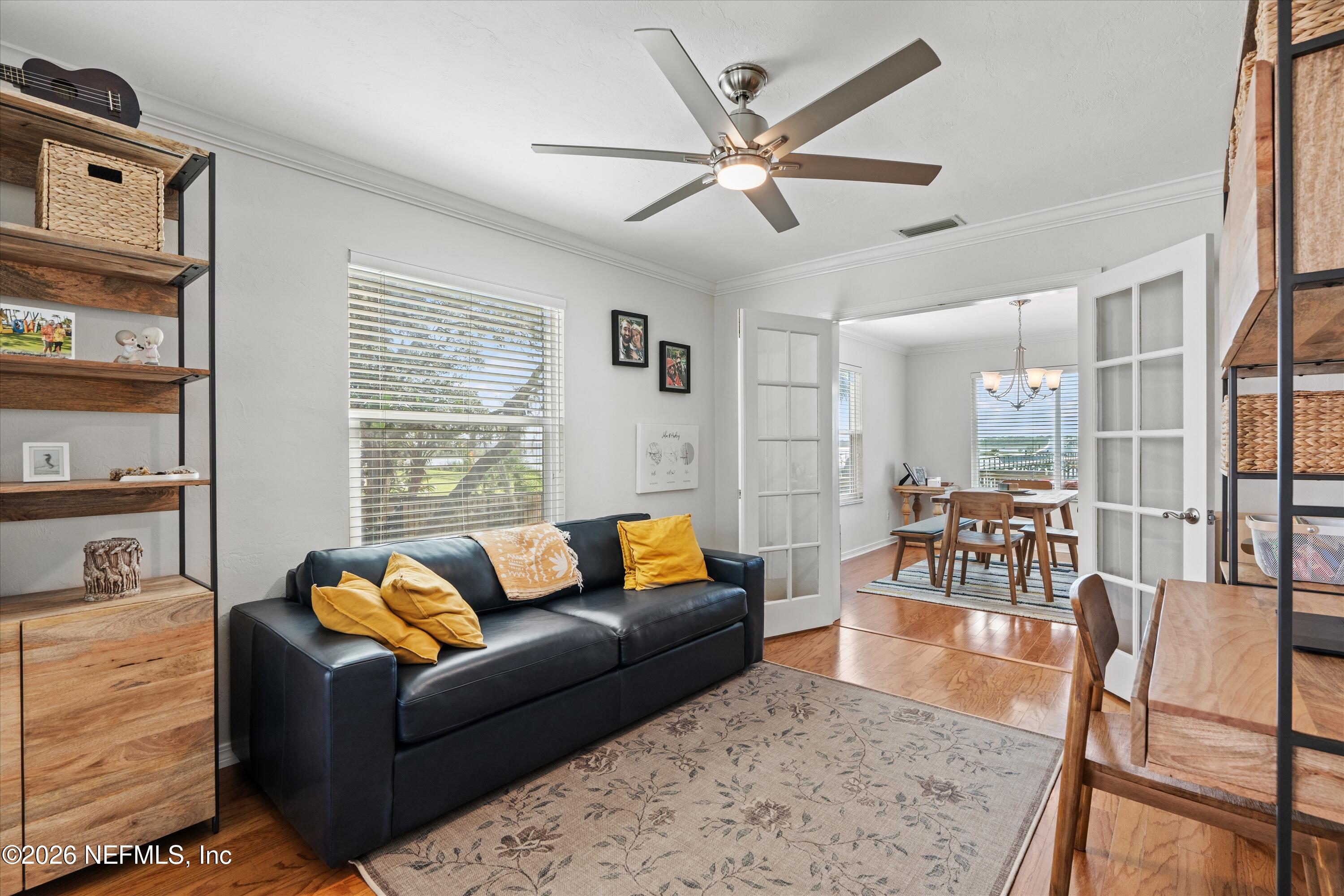5532 Sunset Landing Circle St. Augustine, FL 32080 - Photo 21 of 43 a living room with furniture wooden floor and a large window